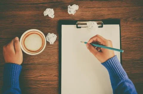 Hand writing with cup of coffee Stock Photos