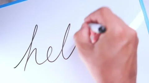 Hand writing cursive hello on whiteboard Stock Footage 326061376