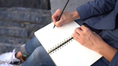 Hand writing in diary, unrecognizable girl writing a poetry by the sea Stock Footage 166120959