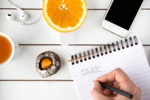 Hand writing to do list with black pen, white wooden table Stock Photos