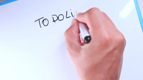 Hand writing a to do list on a whiteboard Stock Footage 326061338