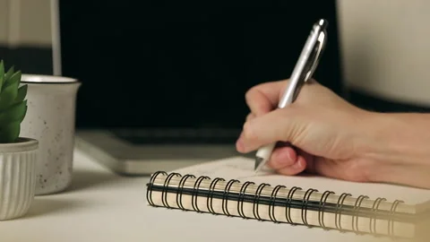 Hand Writing Down Notes Quickly on Notepad Paper with Pen on Desk Video stock 236584851