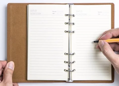 Hand Writing on to Empty Diary Organizer notebook 库存照片