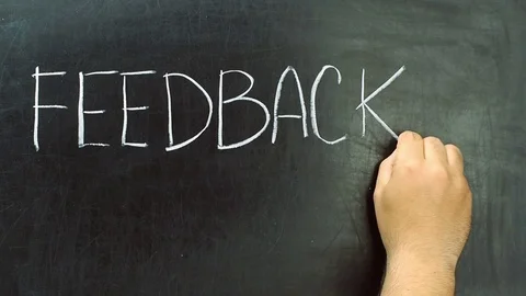 Hand writing feedback word with chalk on blackboard or chalkboard 動画素材 74687273