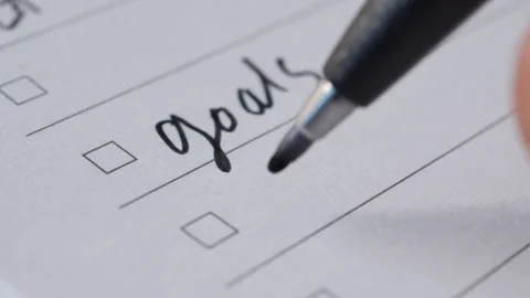 Hand writing goals plan action on checklist with pen ticking boxes. Stock Footage 332745710