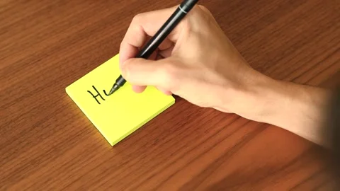 Hand Writing 'Hello' on Sticky Note Stock Footage 328331195