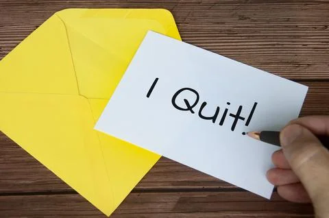 Hand writing I quit text on white notepad with yellow envelope background. .. Stock Photos