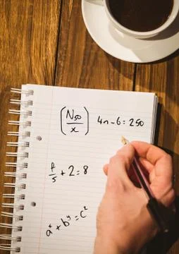 Hand writing math sums on notepad Stock Photos