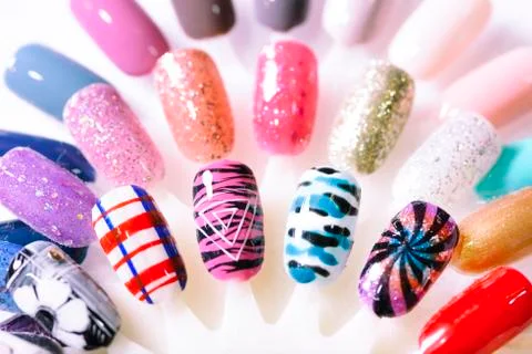 Hand writing nail tips, examples of different colorful nail desi Stock Photos
