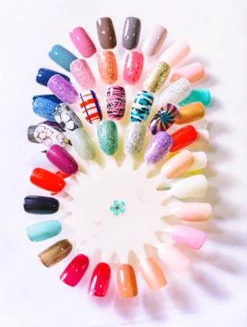 Hand writing nail tips, examples of different colorful nail desi Фото