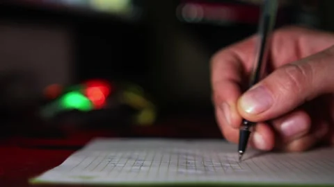 Hand writing a note with festive background lights 動画素材 332599721