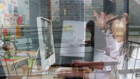 Hand writing note starting camera pullback, front woman typing on desktop and Stock Footage 333004745
