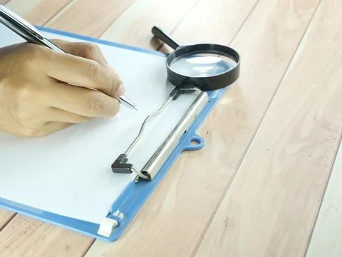 Hand writing in notebook on brown background. Insurance or financial busine.. Stock Photos