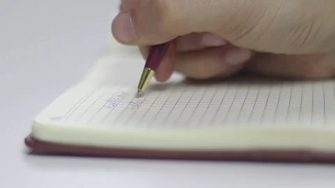 A Hand Writing On A Notebook Stock Footage 233858176