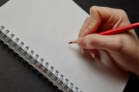 Hand writing on notebook with pencil Stock Photos