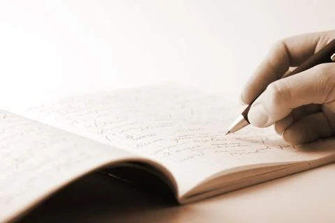 Hand writing in notebook Stock Photos