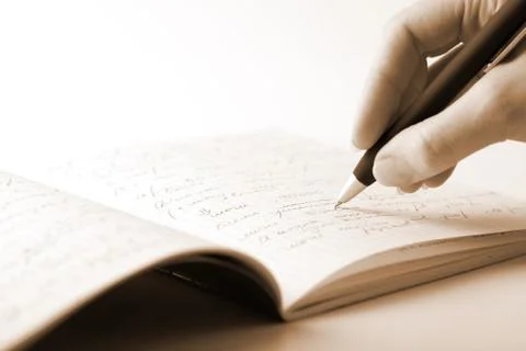 Hand writing in notebook Stock Photos