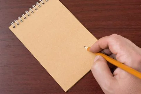 Hand writing in notebook Stock Photos