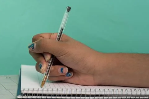 Hand writing in the notebook. Stock Photos