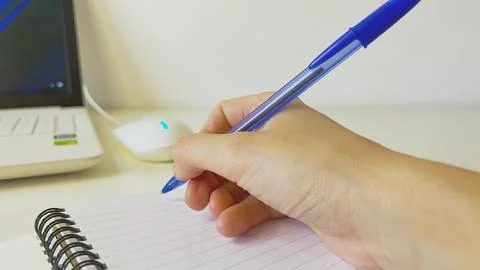 Hand Writing in Notebook at Workspace Stock Photos