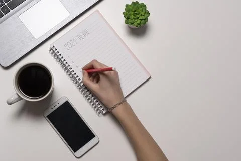 Hand writing notepad. view from the top of the office desk table. Working spa Stock Photos