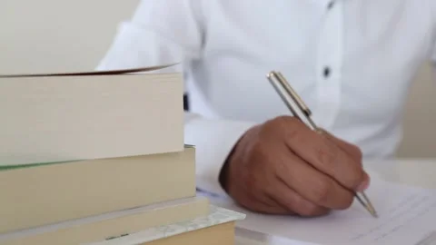 Hand Writing Notes Among Stacked Books Stock Footage 346182666
