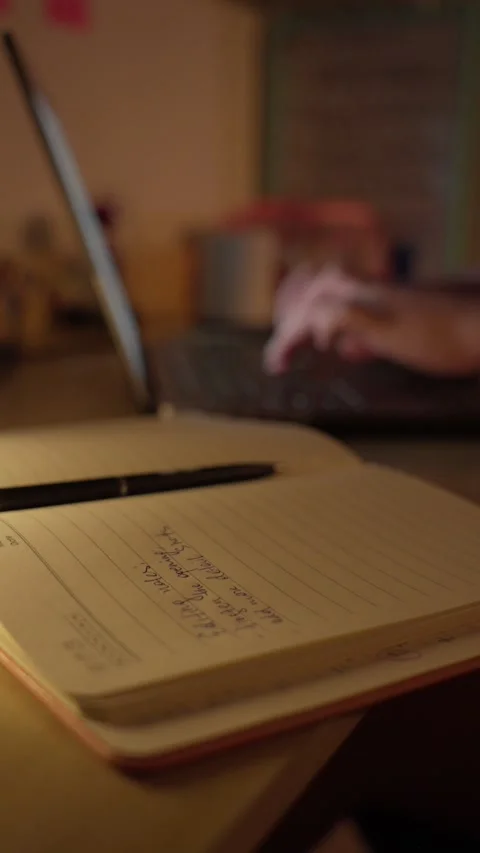 Hand Writing Notes in Notebook at Desk in Warm Light Stock Footage 344949774
