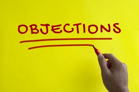 Hand writing objections text on yellow background. Stock Photos