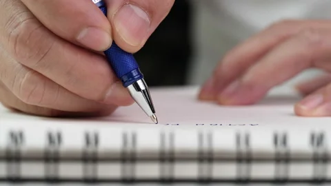 Hand writing paper on notebook with blue pen to note, memo, list action plan Stock Footage 204764665