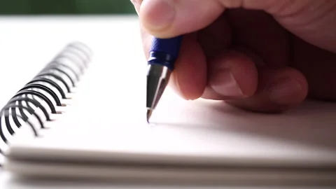 Hand writing paper on notebook with blue pen to note, memo, list action plan Stock Footage 204764799
