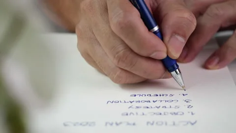 Hand writing paper on notebook with blue pen to note, memo, list action plan Stock Footage 204765177