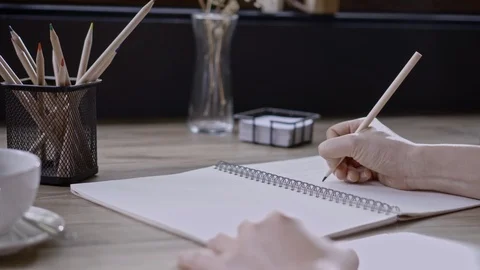 Hand writing the pencil to in book with table, view of room on the morning 스톡 동영상 104842064