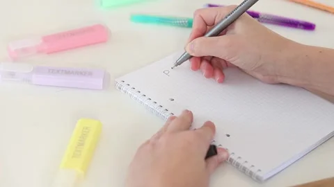 Hand writing plan and checking boxes in notebook on white table Stock Footage 331801621