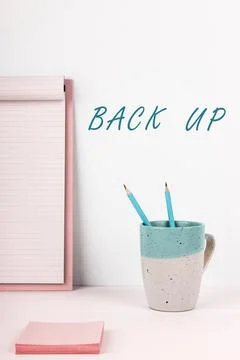 Hand writing sign Back Up. Internet Concept saving important data into internet Stock Photos