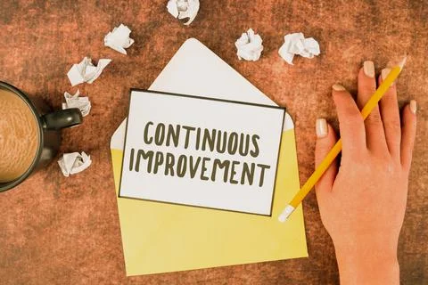 Hand writing sign Continuous Improvement. Business concept making small Stock Photos