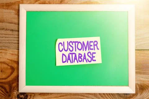 Hand writing sign Customer Database. Word Written on uptodate on customer Stock Photos