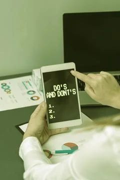 Hand writing sign Do s is And Don t notsTechnologically complication of making a Stock Photos