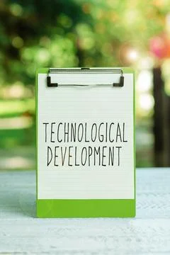 Hand writing sign Technological Development. Business showcase Invention or Stock Photos