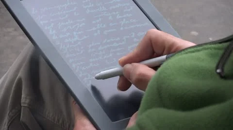 Hand writing on tablet mobile computer author Stock Footage 12478098