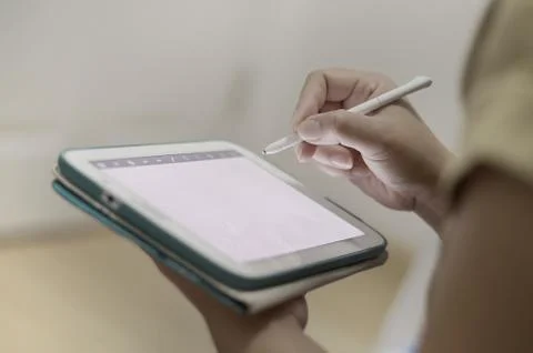 Hand writing on a tablet Stock Photos