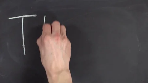 Hand writing "TEAM" with white chalk on blackboard Stock Footage 84037257