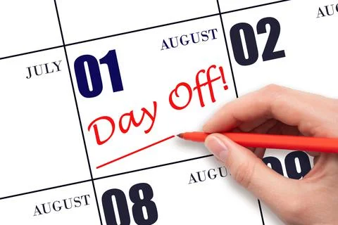 Hand writing text DAY OFF and drawing a line on calendar date 1 August. Vacat Stock Photos