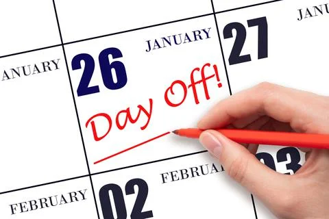 Hand writing text DAY OFF and drawing a line on calendar date 26 January. Vac Foto stock