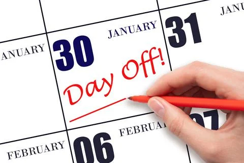 Hand writing text DAY OFF and drawing a line on calendar date 30 January. Vac Stock Photos