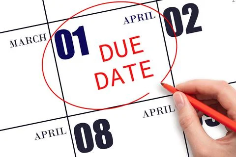 Hand writing text DUE DATE on calendar date April 1 and circling it. Payment  Stock Photos