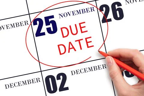 Hand writing text DUE DATE on calendar date November 25 and circling it. Paym Stock Photos