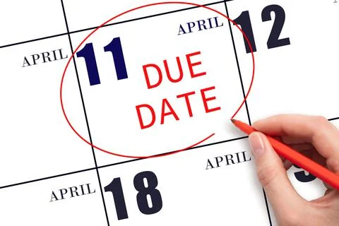 Hand writing text DUE DATE on calendar date April 11 and circling it. Payment Stock Photos