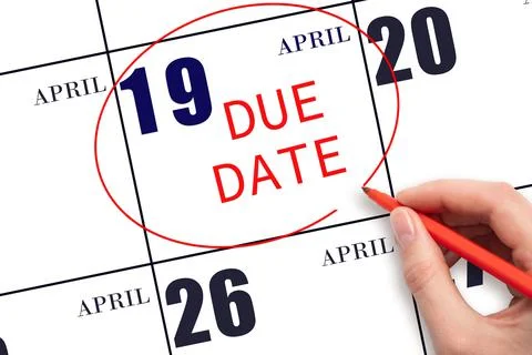 Hand writing text DUE DATE on calendar date April 19 and circling it. Payment Stock Photos