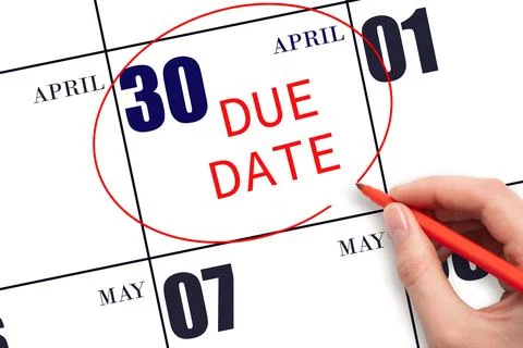 Hand writing text DUE DATE on calendar date April 30 and circling it. Payment Stock Photos