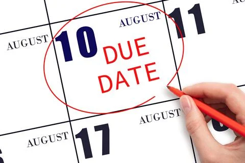 Hand writing text DUE DATE on calendar date August 10 and circling it. Paymen Stock Photos